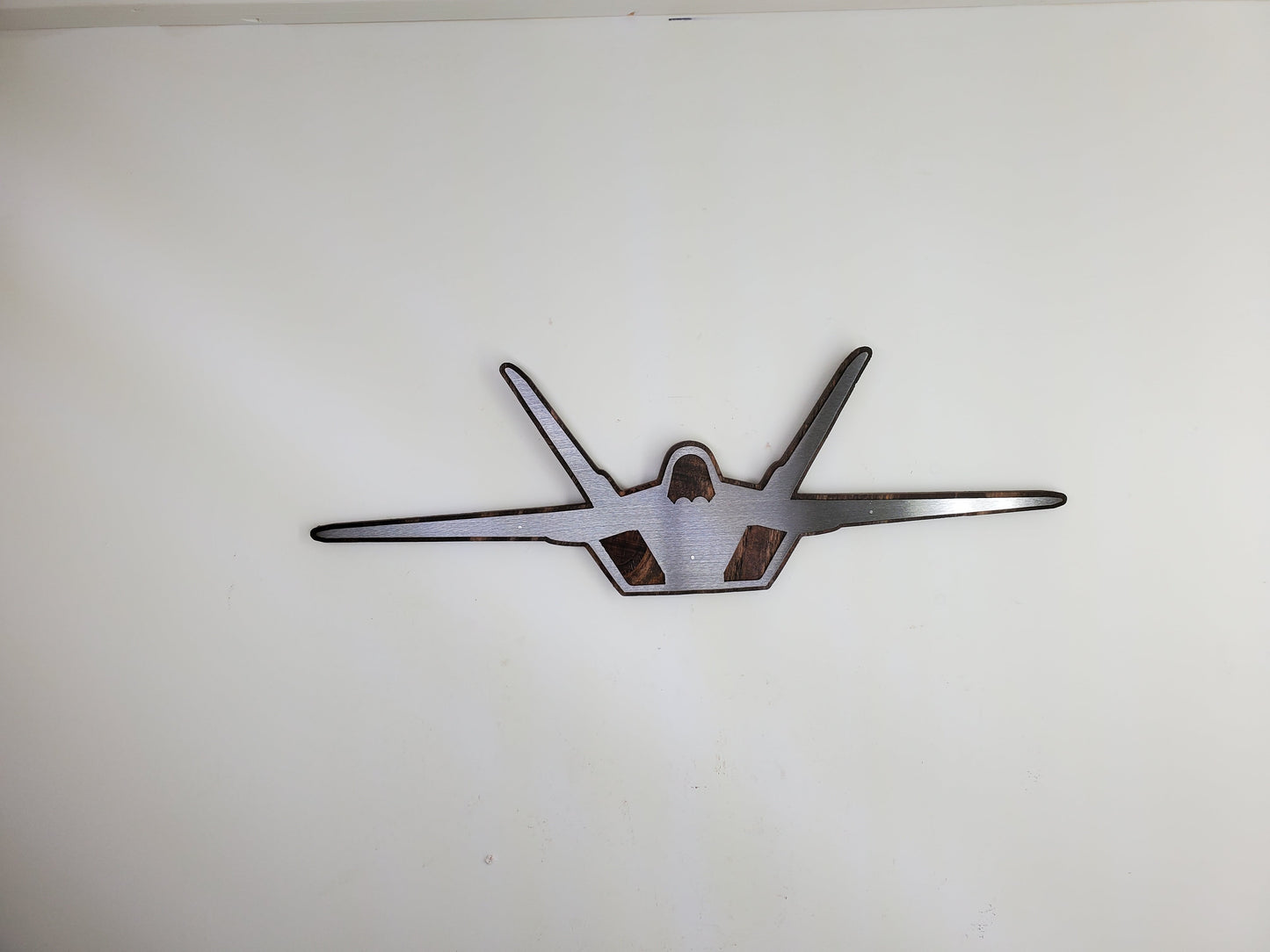 f-22 raptor metal art on stained wood
