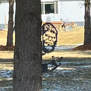 Bigfoot mounted on a tree with finger
