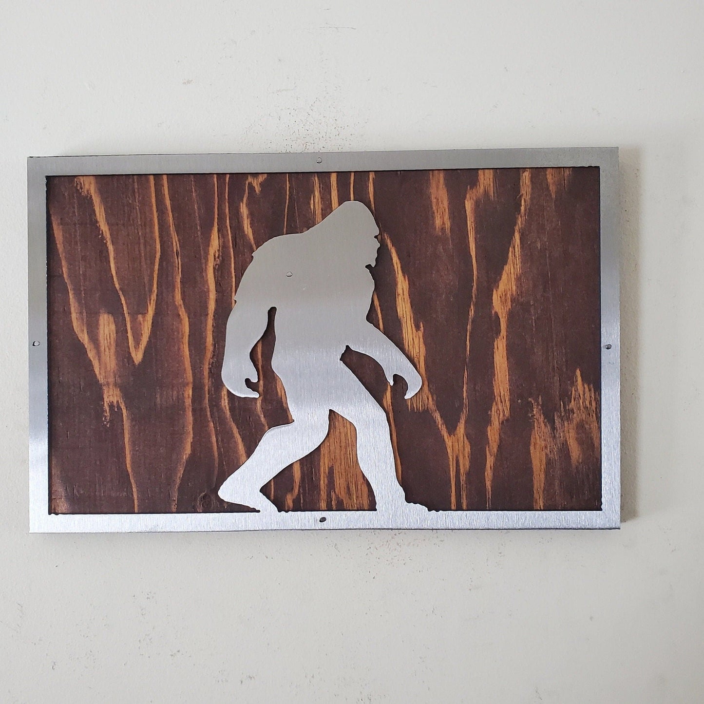 Bigfoot metal art on wood sign