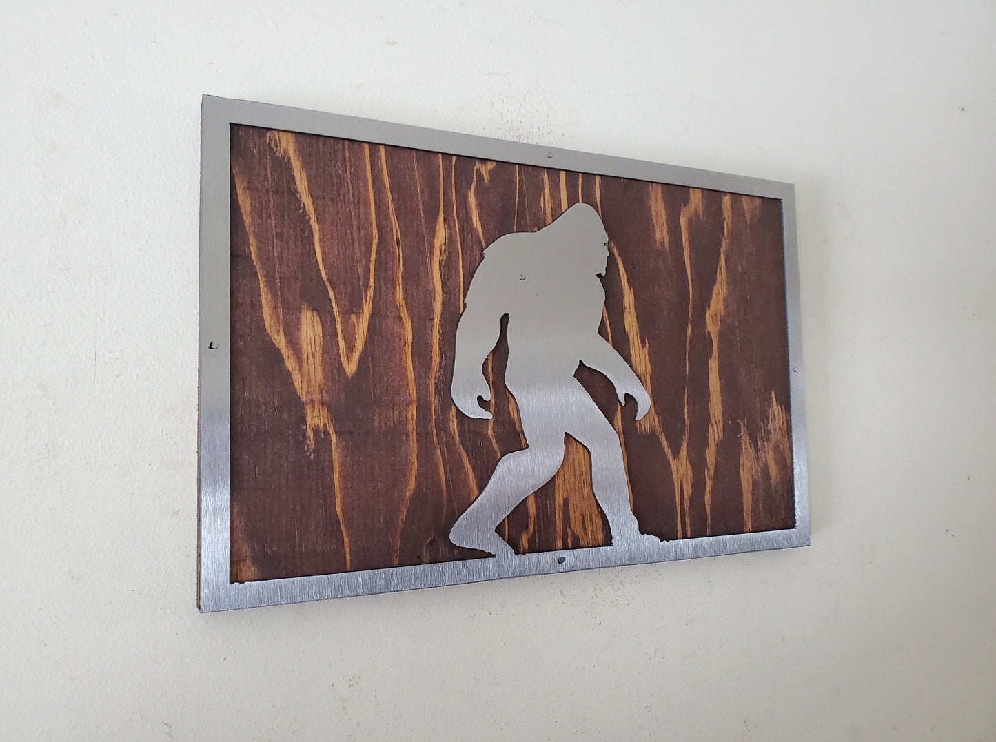 Bigfoot metal art on wood sign