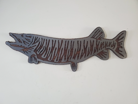 This Muskie fish sculpture art is a beautiful and unique wall decor piece, featuring an artistic representation of the elusive and challenging king catch - the Muskie. It is made using rustic stained wood and clear-coated steel