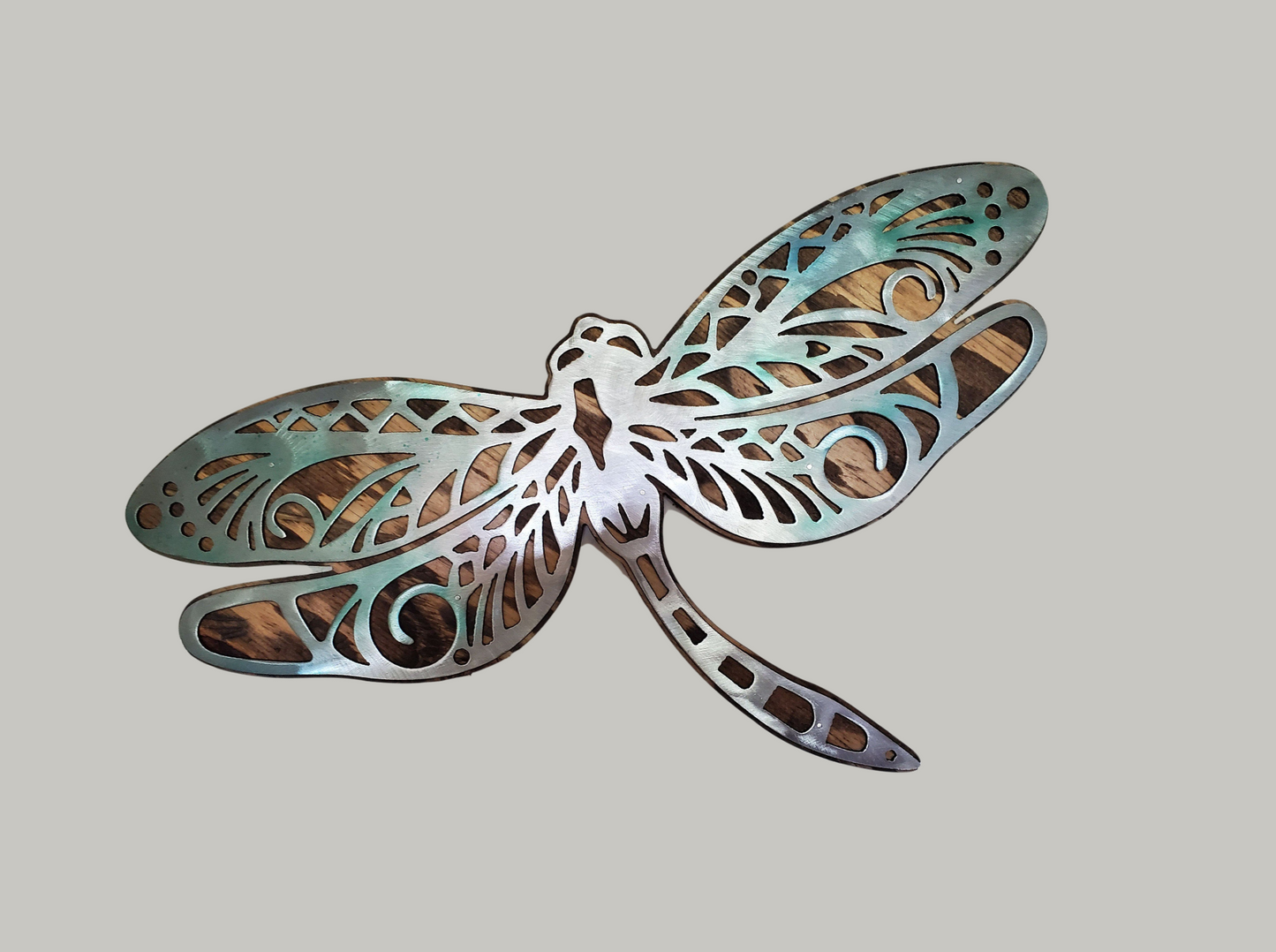  beautiful Dragonfly metal and wood wall sculpture, the perfect addition to any home looking for a unique piece of metal art home decor. This sculpture is made in our family shop in Minnesota, using rustic stained wood and clear-coated steel.