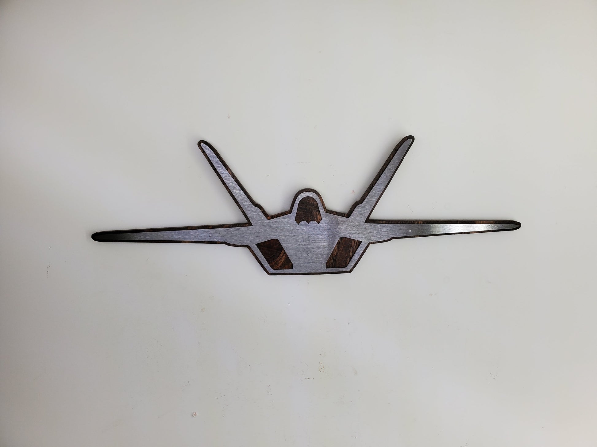 f-22 raptor metal art on stained wood