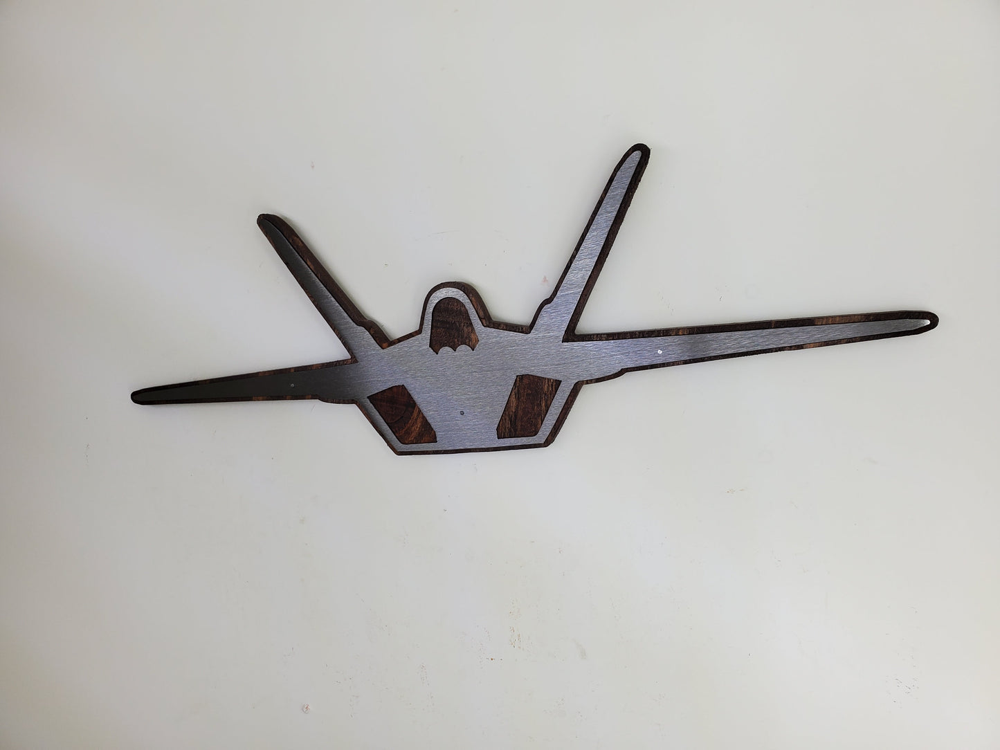 f-22 raptor metal art on stained wood