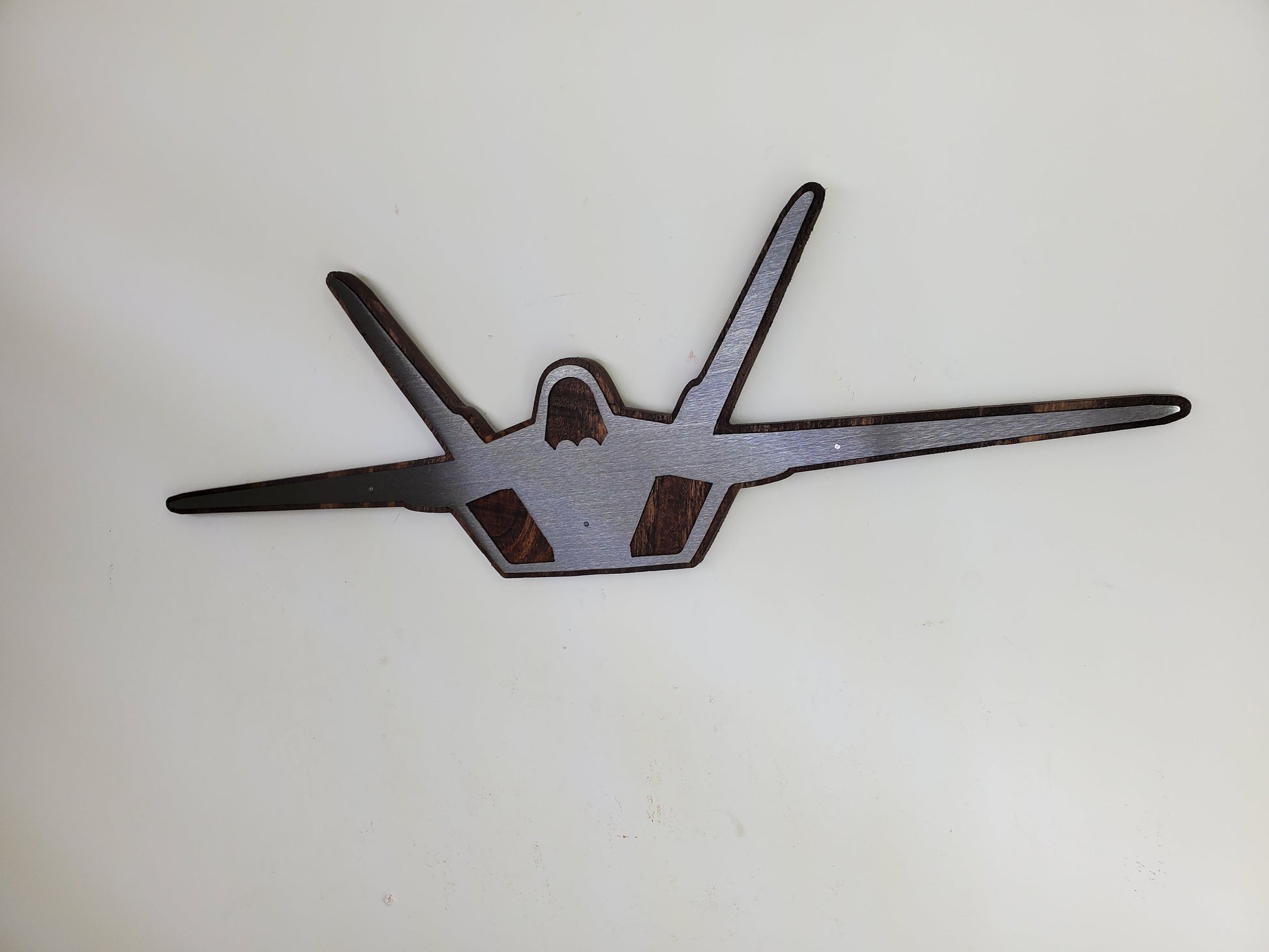 f-22 raptor metal art on stained wood