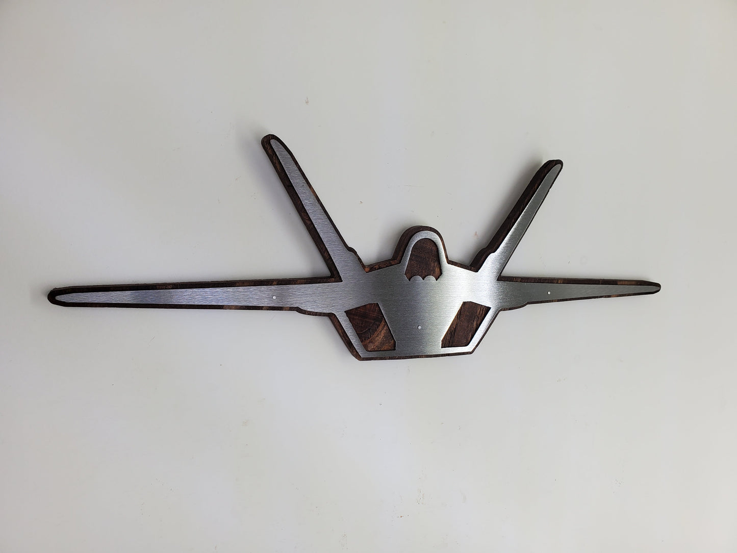 f-22 raptor metal art on stained wood