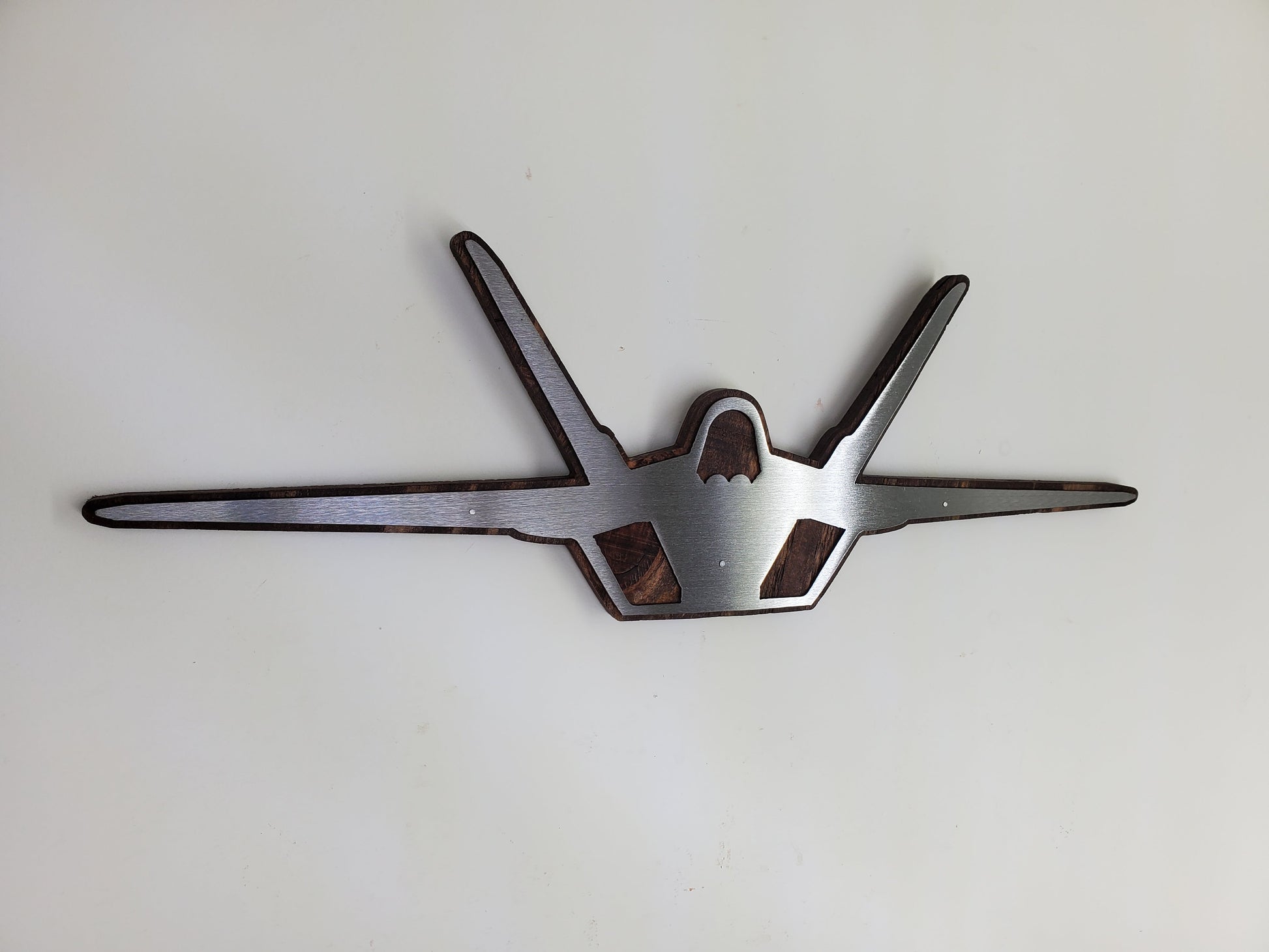 f-22 raptor metal art on stained wood