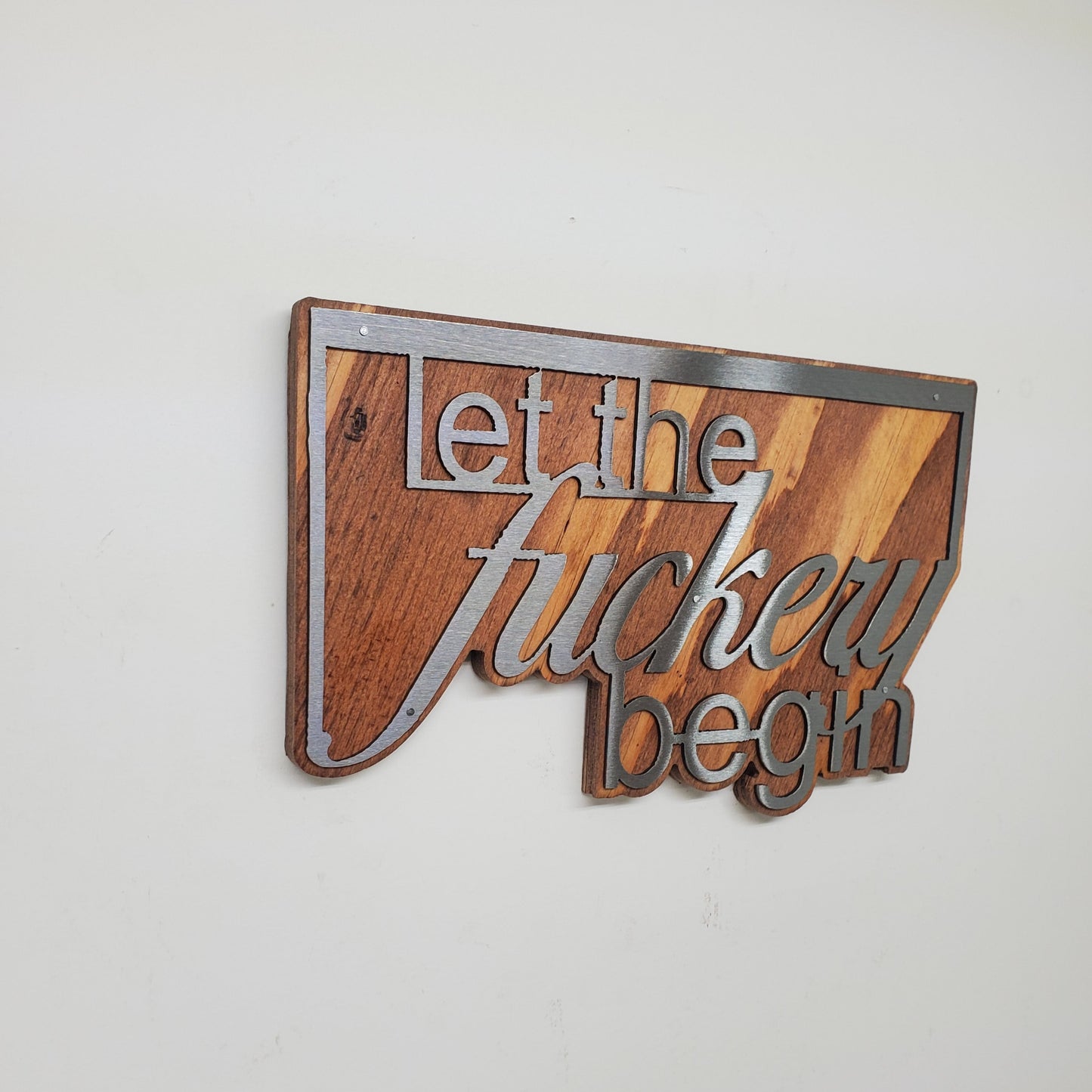 Decorative Word Cut Out on Stained Wood Background, A Unique and Stylish wall decor piece, made of steel cutout of the word Shenanigans on a stained wood background, it comes with saw tooth style hanger for easy mounting