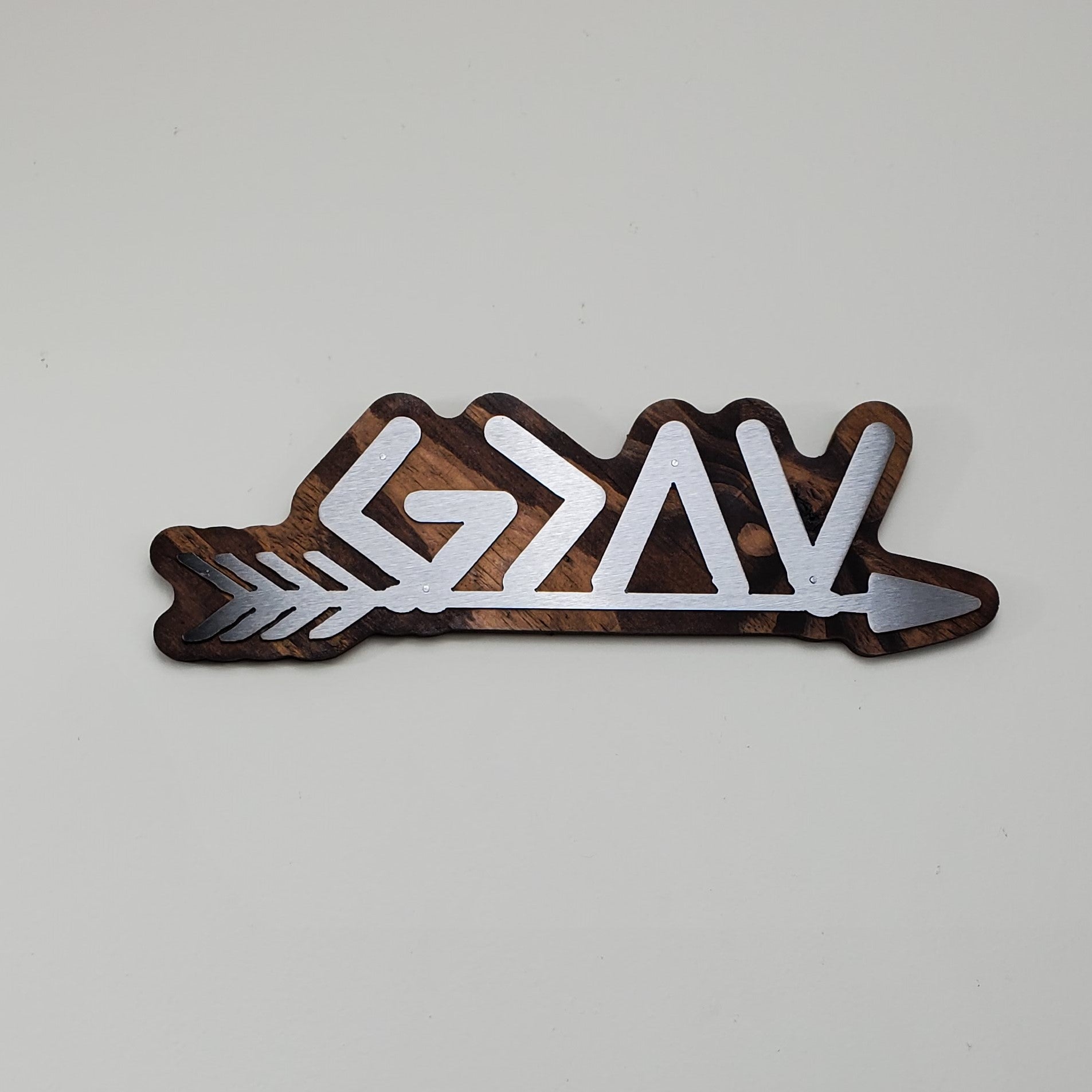 Romans 8:28: God is Greater Than the Highs and Lows greek letters on an arrow Christian Gift. Metal art on stained wood background. Beamish metal works