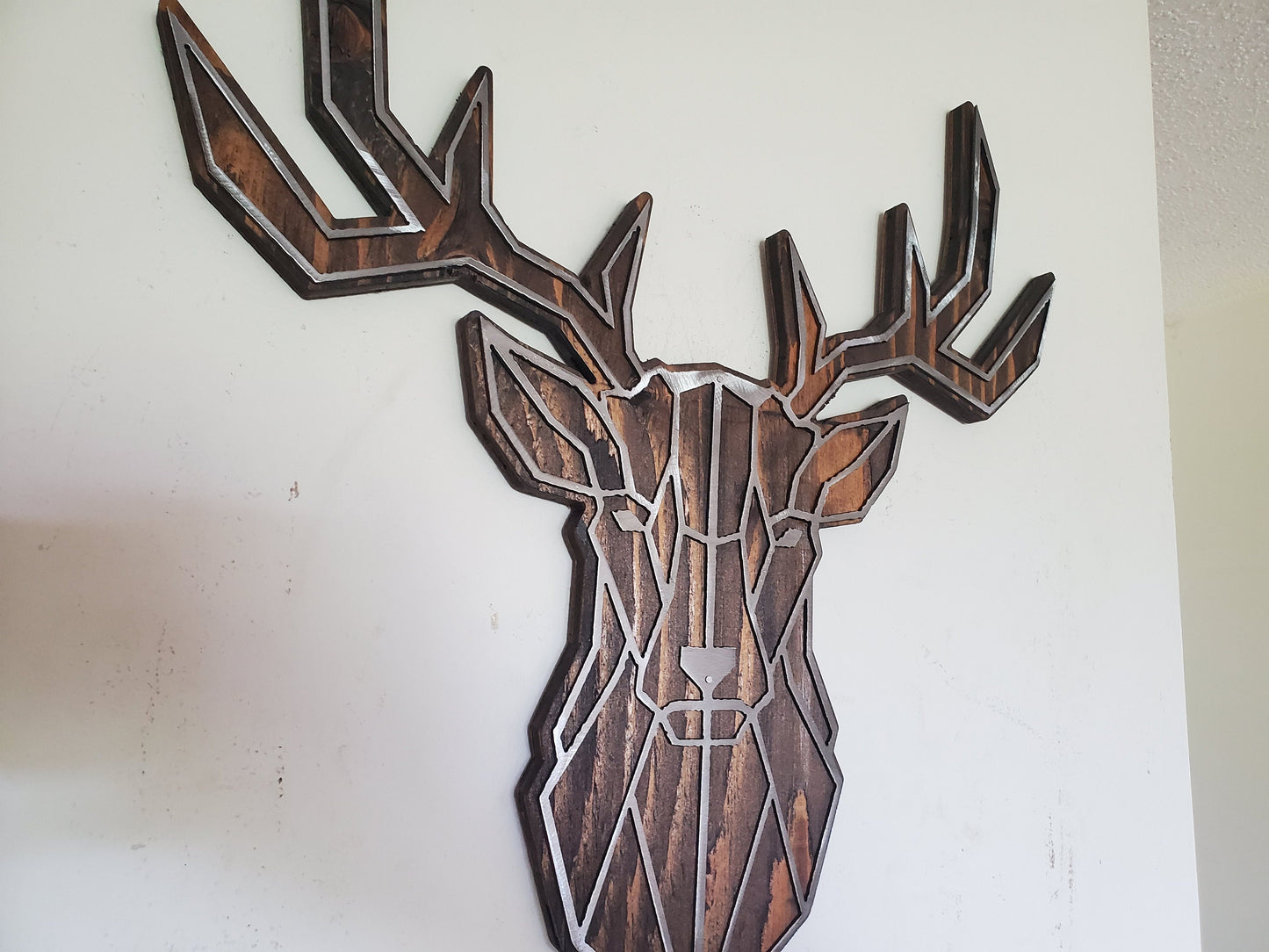 Geometric Buck Head Metal Art on Rustic Stained Wood