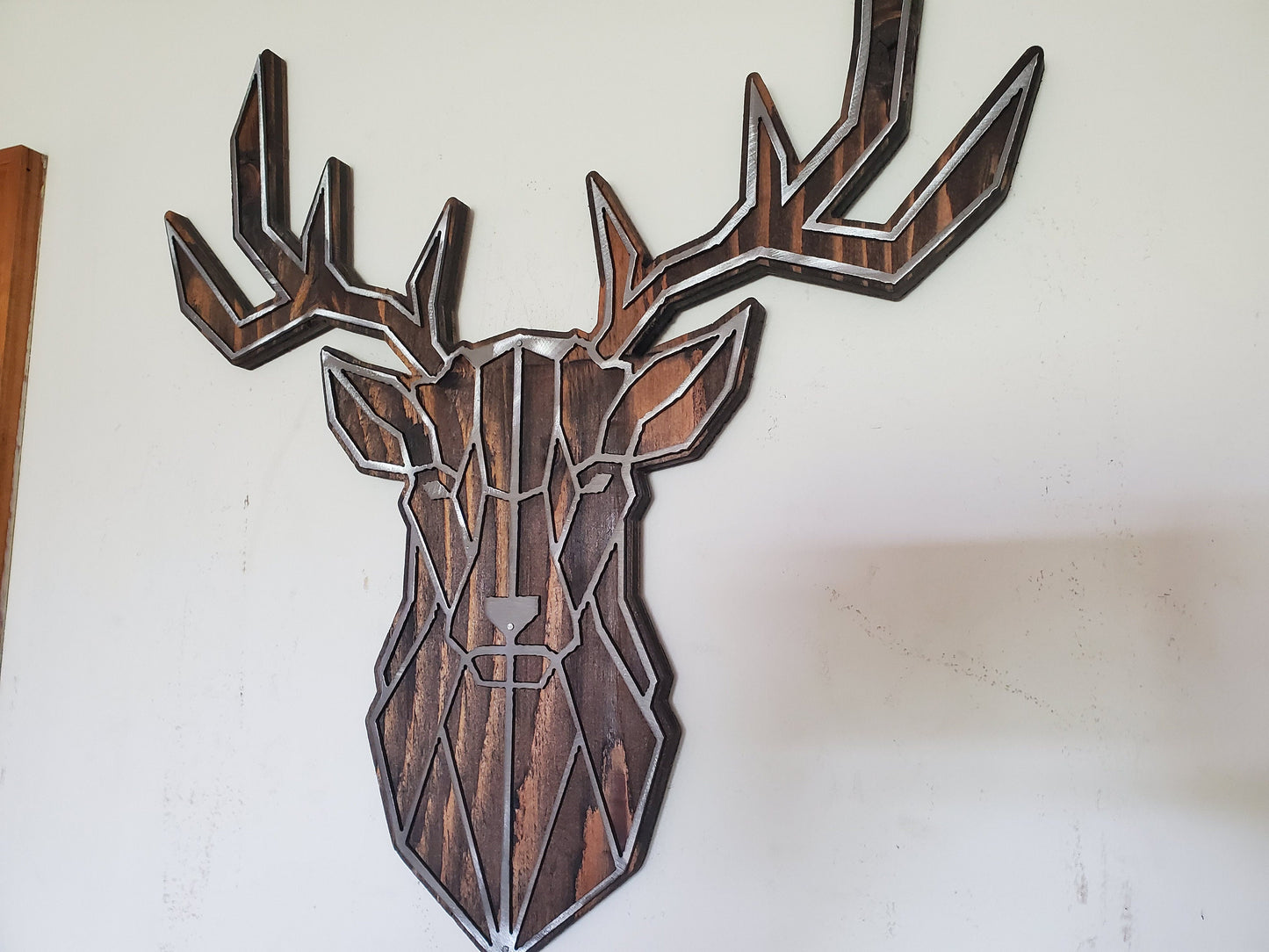 Geometric Buck Head Metal Art on Rustic Stained Wood