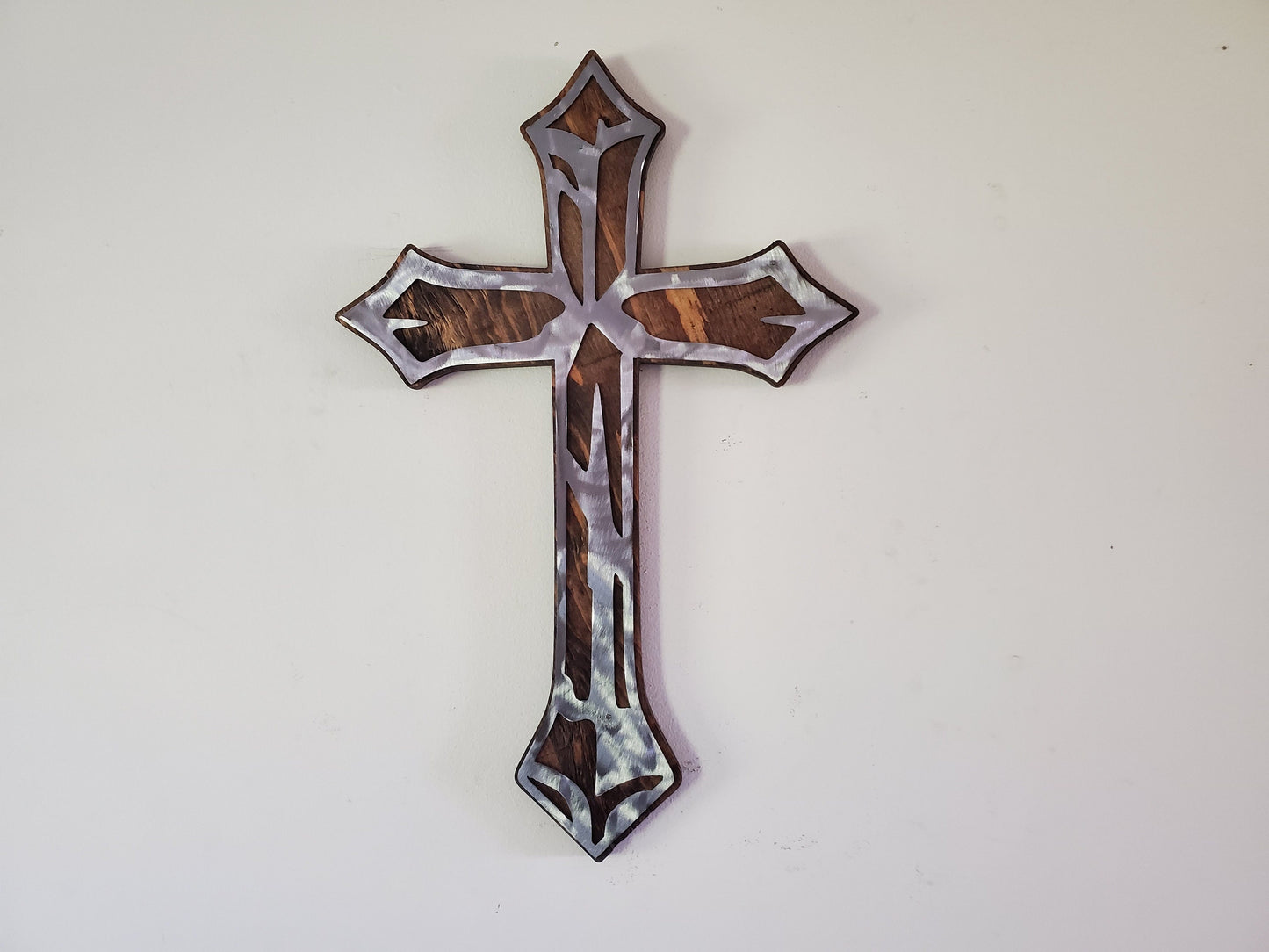 Distressed cross metal art on wood beamish metal works