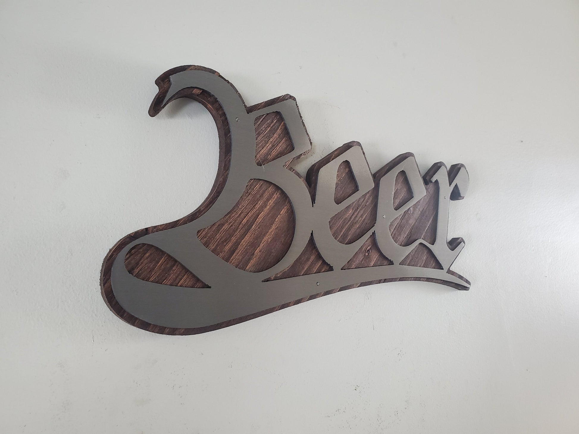 Beer stylized word metal art on stained wood decor