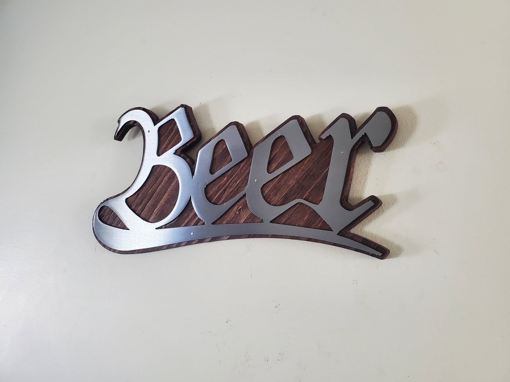 Beer stylized word metal art on stained wood decor