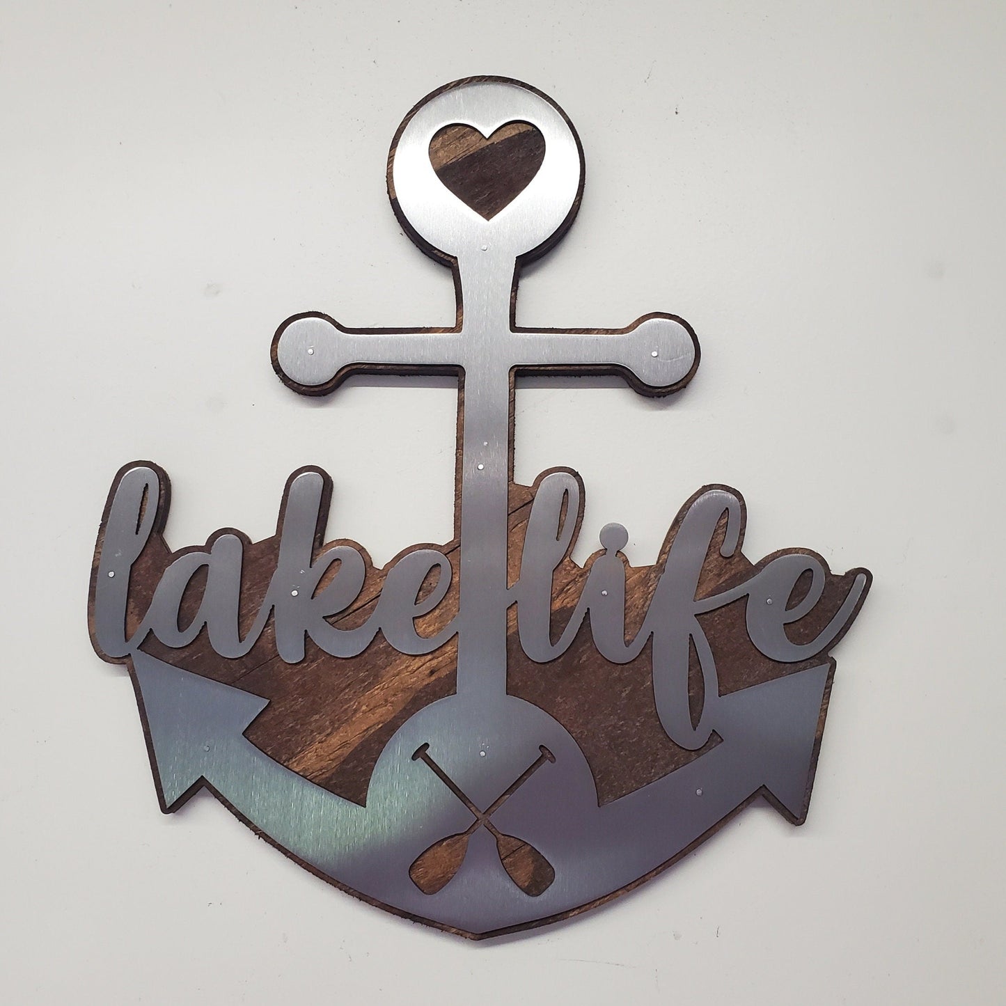  beautiful metal art wall decor of an Anchor, perfect for all the "lake life" enthusiasts out there. The Anchor made in our family shop in Minnesota. The words "lake life" are cut into the Anchor adding a unique touch to the piece.