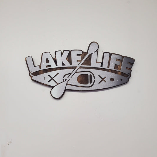 This is a Lake Life Kayak metal art wall decor on a stained wood background. This is the perfect wall decor for a lake home, cabin or office. Or a unique gift. This detailed metal cut out is attached to a stained wood back ground