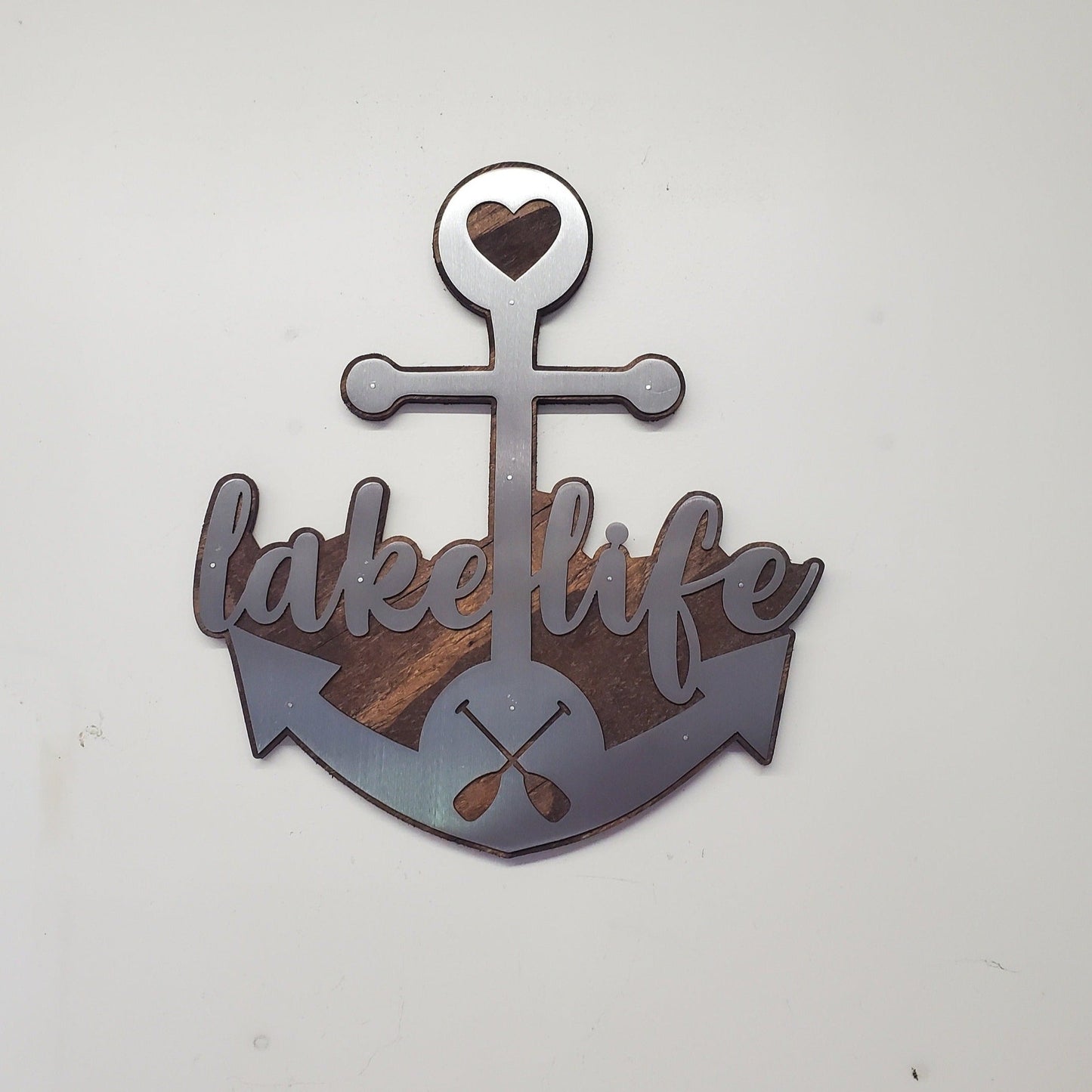  beautiful metal art wall decor of an Anchor, perfect for all the "lake life" enthusiasts out there. The Anchor made in our family shop in Minnesota. The words "lake life" are cut into the Anchor adding a unique touch to the piece.