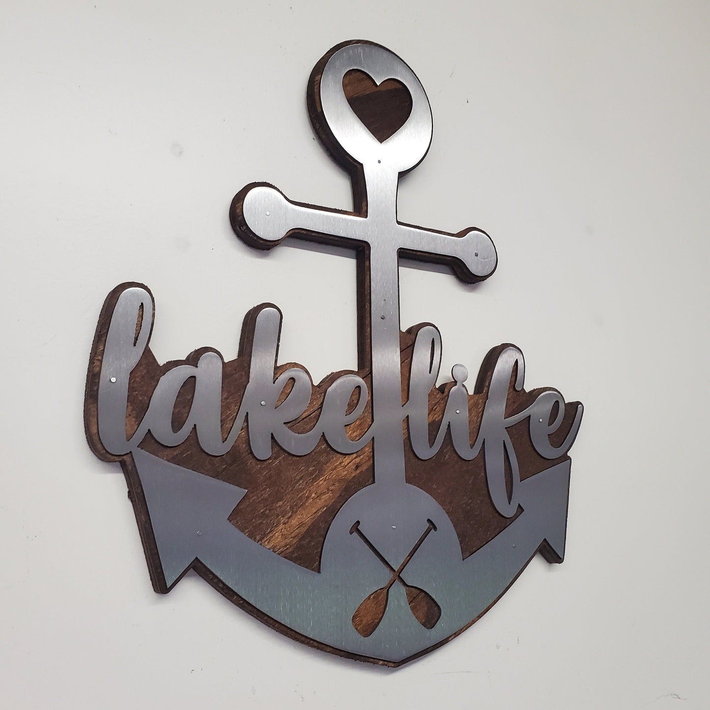  beautiful metal art wall decor of an Anchor, perfect for all the "lake life" enthusiasts out there. The Anchor made in our family shop in Minnesota. The words "lake life" are cut into the Anchor adding a unique touch to the piece.