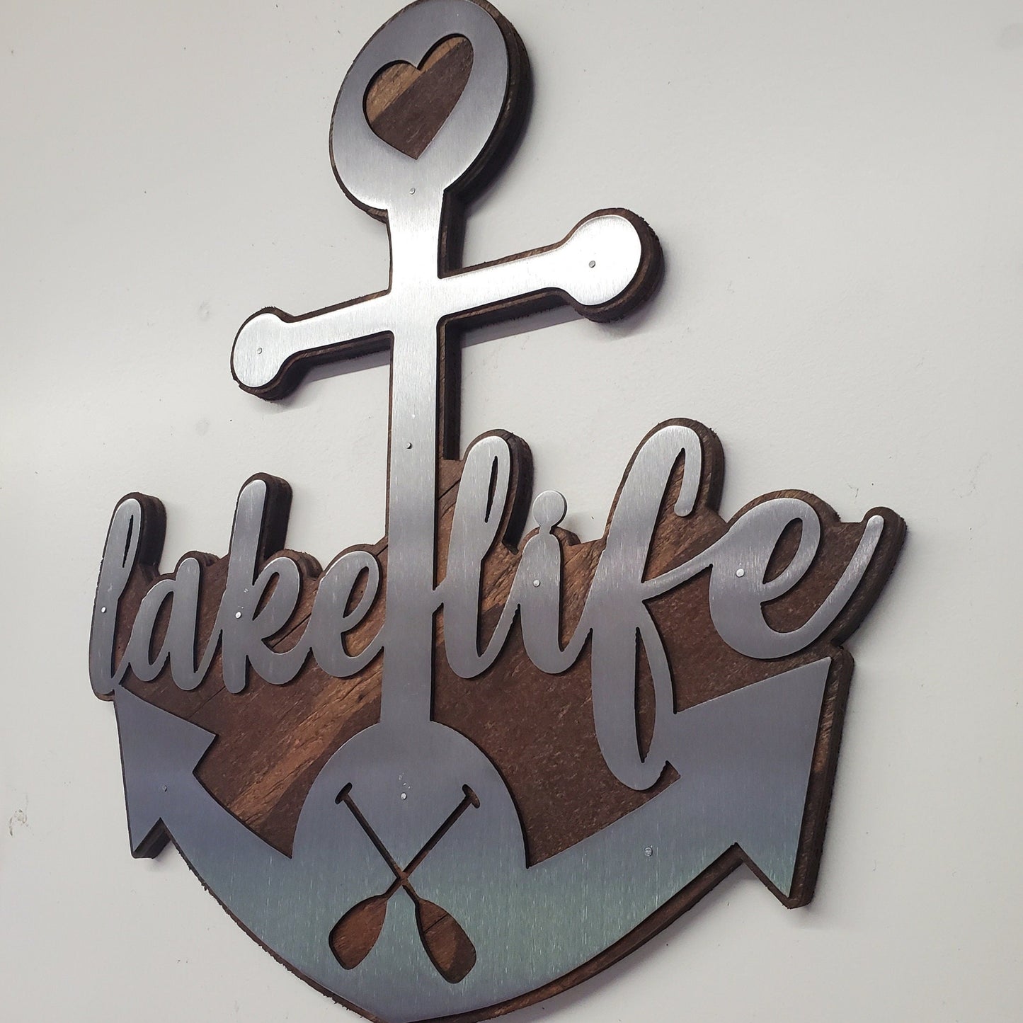  beautiful metal art wall decor of an Anchor, perfect for all the "lake life" enthusiasts out there. The Anchor made in our family shop in Minnesota. The words "lake life" are cut into the Anchor adding a unique touch to the piece.