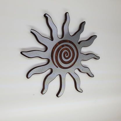 southwestern sun metal art wall decor on stained wood background.
