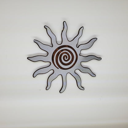 southwestern sun metal art wall decor on stained wood background. 