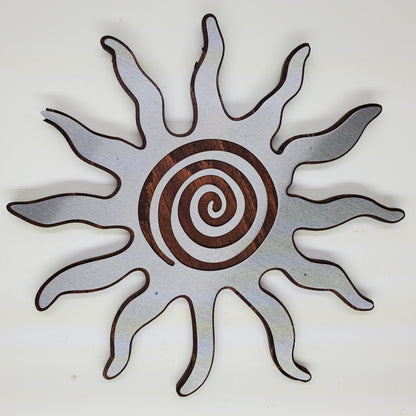 southwestern sun metal art wall decor on stained wood background.