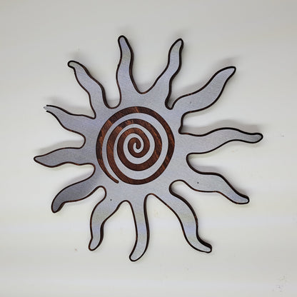 southwestern sun metal art wall decor on stained wood background.
