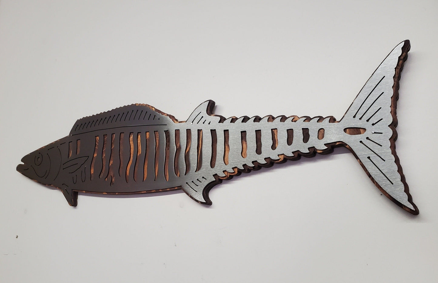 Wahoo Fish Metal Cutout on Stained Wood Background, A Unique and Stylish wall decor piece, made of metal cutout of Wahoo fish shape on a stained wood background, it comes with saw tooth style hanger for easy mounting